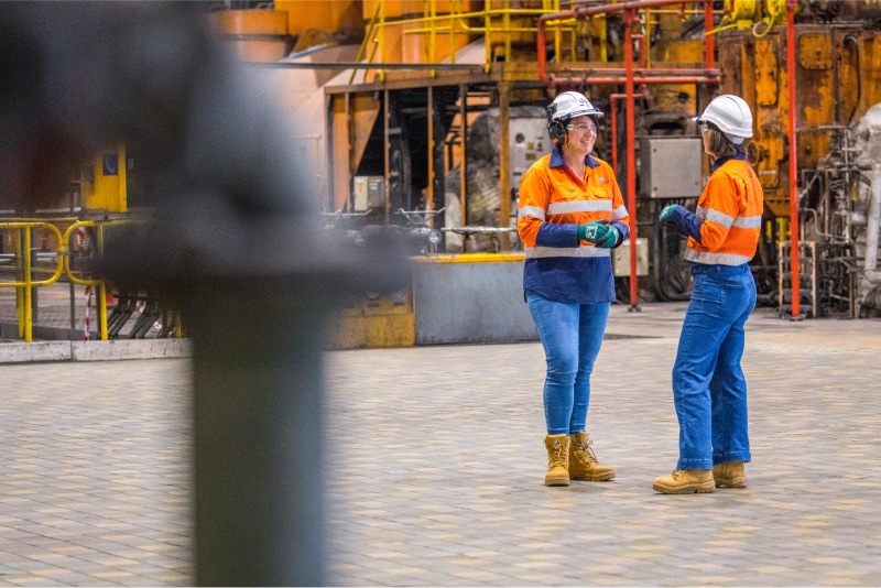 Two women chatting at one of our power generation facilities