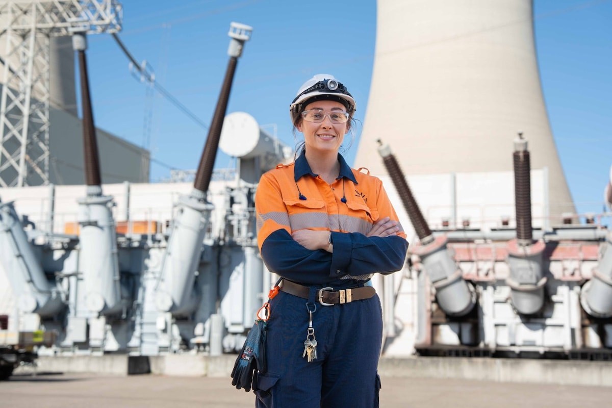 Staff member standing in front of power station