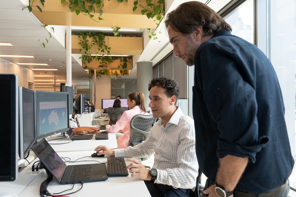 AGL team members gathering around a computer