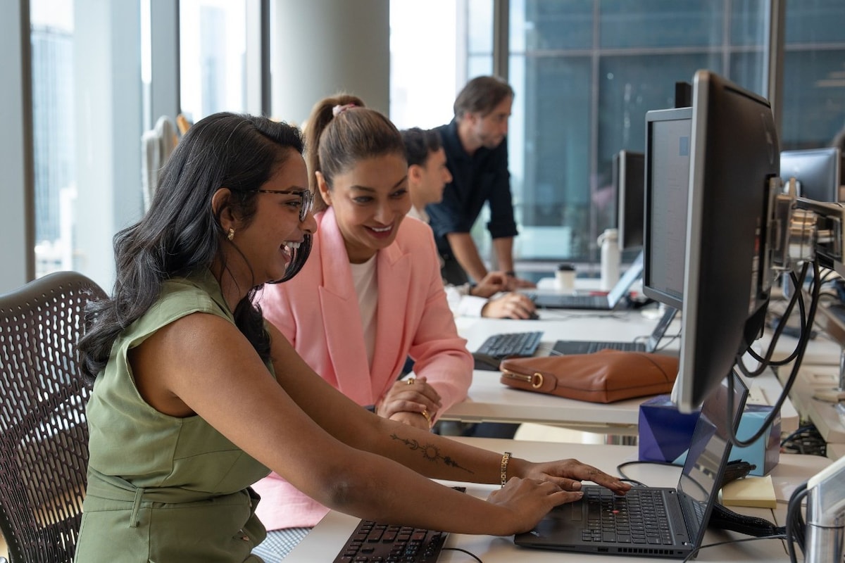 AGL team members looking at computer screen