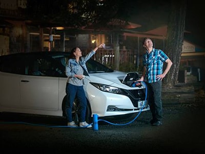 Nissan EV being charged at night