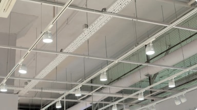 View from the ground of an LED light installation on the ceiling of a large factory