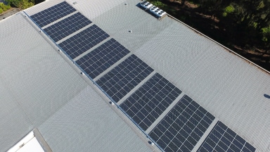 Aerial shot of a chocolate factory with solar panels on the roof