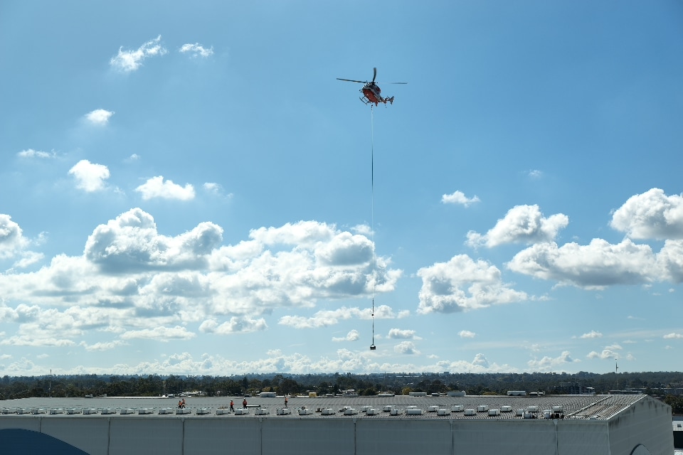 Helicopter flying low over a building