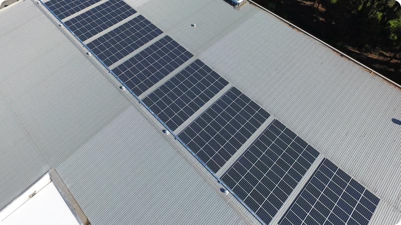 Aerial shot of a chocolate factory with solar panels on the roof