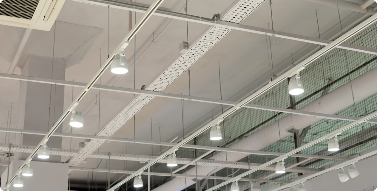 View from the ground of an LED light installation on the ceiling of a large factory