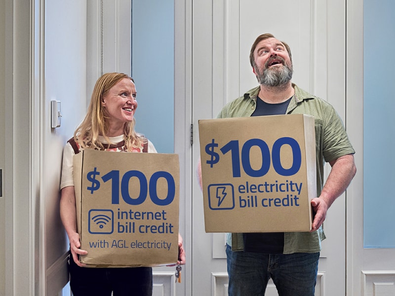 Couple carrying moving boxes