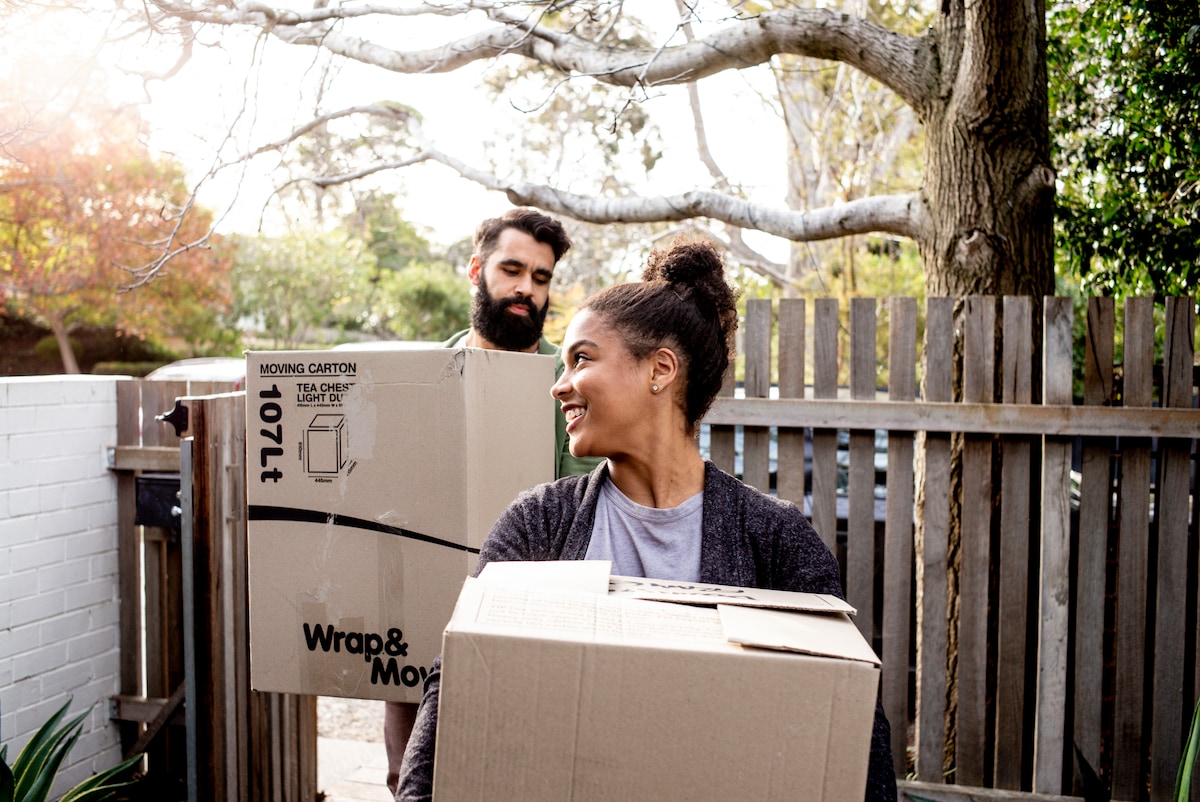 A man and a woman moving boxes
