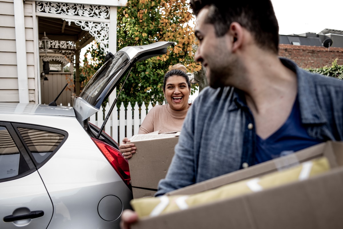 A man and a woman moving boxes