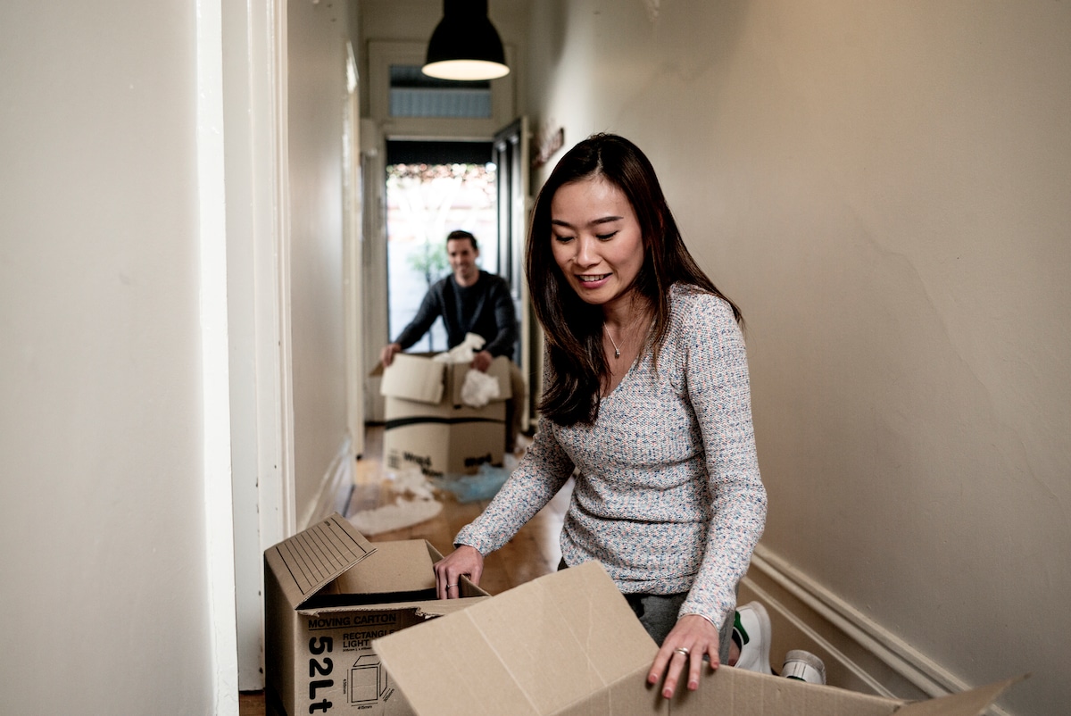 A man and a woman moving boxes