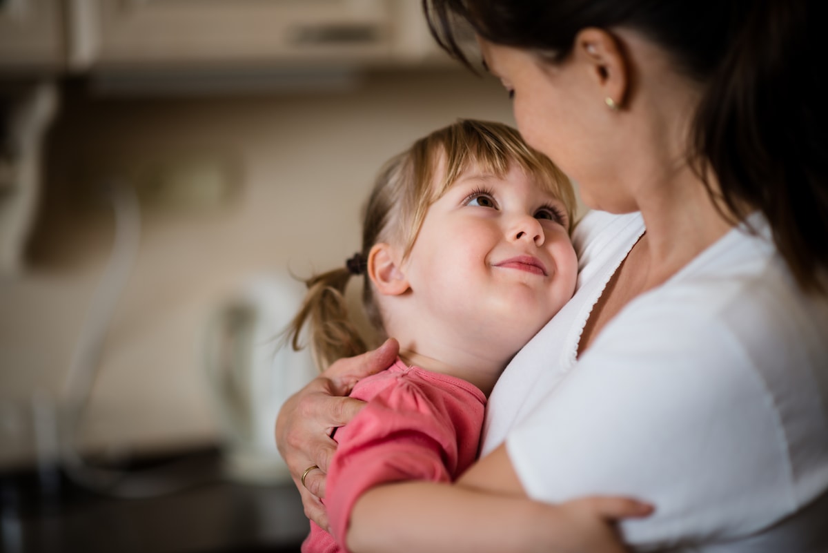 A mother and child holding each other