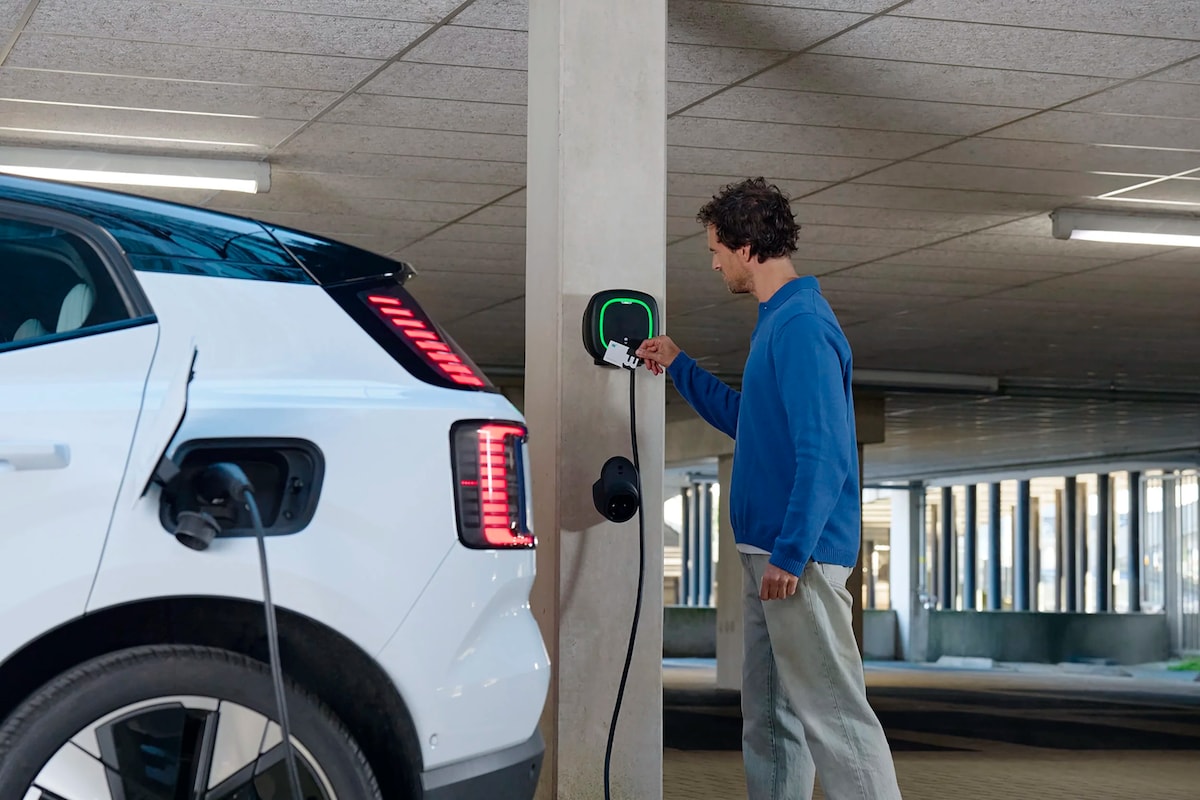A man swiping a public charger with a credit card