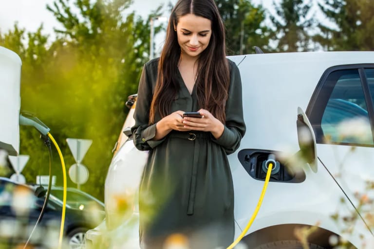 Person charging electric vehicle
