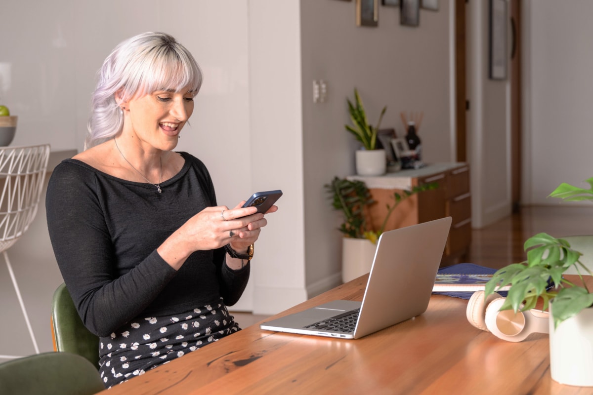 Woman smiling at mobile phone