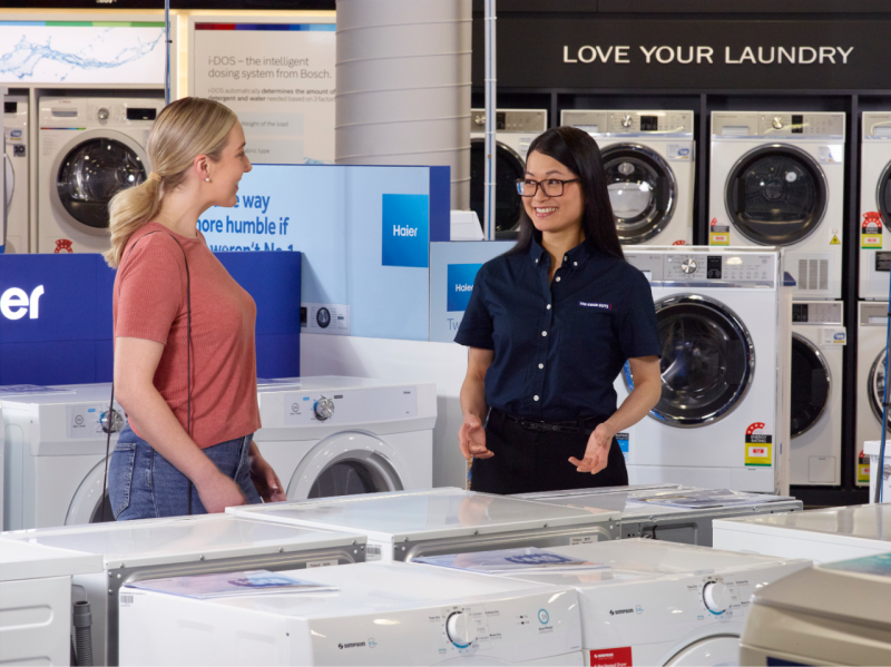 The Good Guys employee with a customer in the washing machine area of the store