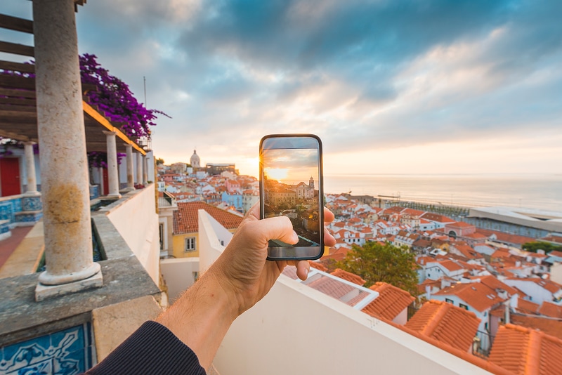 A person taking a photo of their view from their balcony in Portugal
