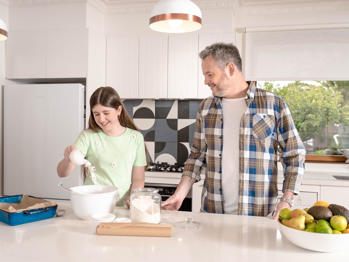 A man and his daughter baking in the kitchen