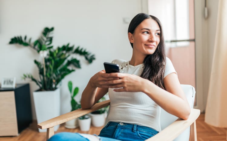 Lady using phone on chair