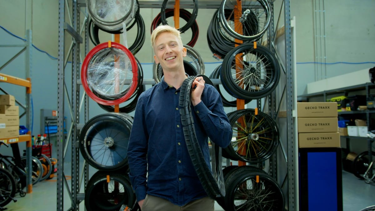 Gecko warehouse employee holding rugged wheelchair tyres