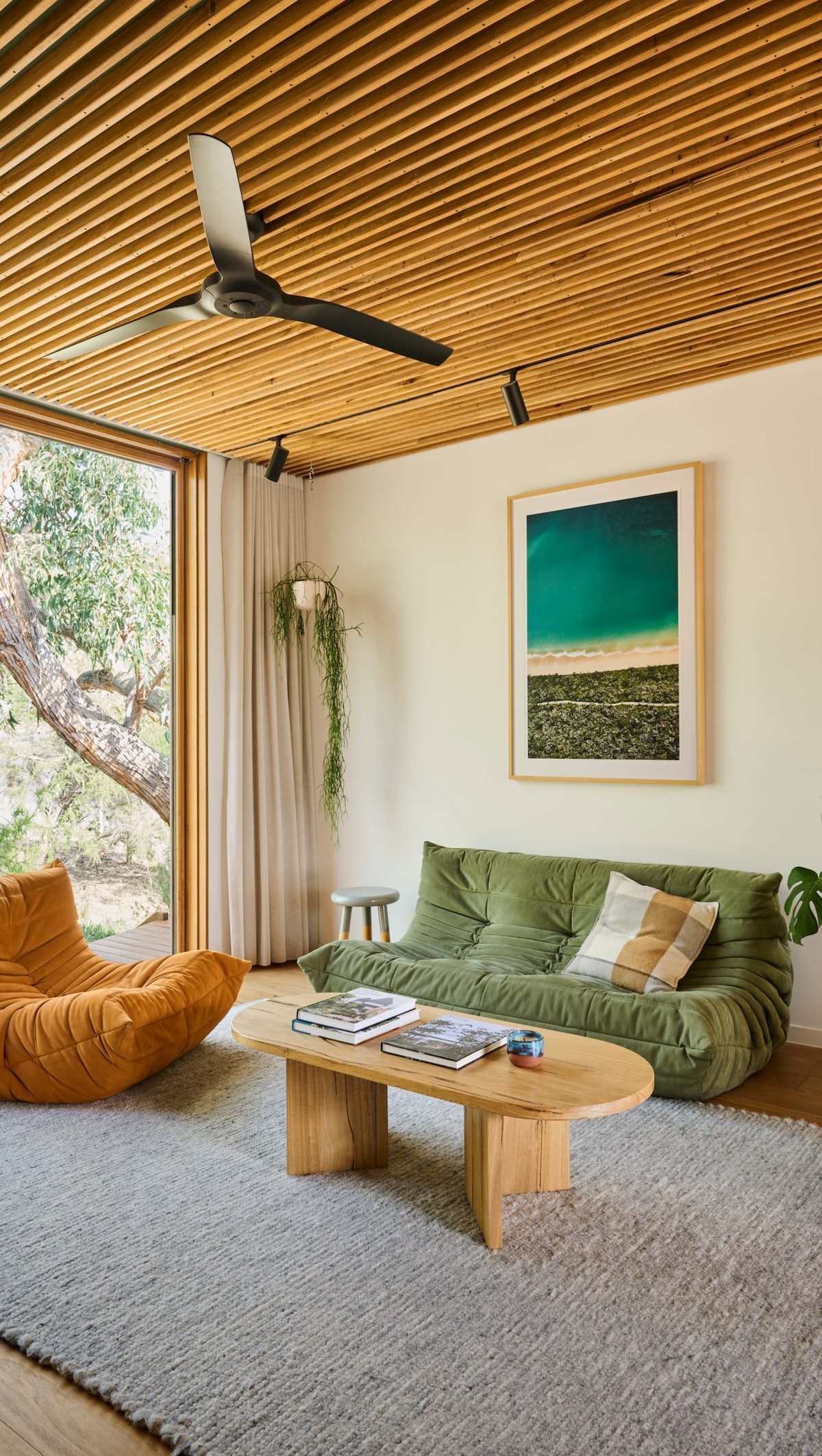A lounge room with a couch, a chair and a small coffee table.. Photograph by Nikole Ramsay
