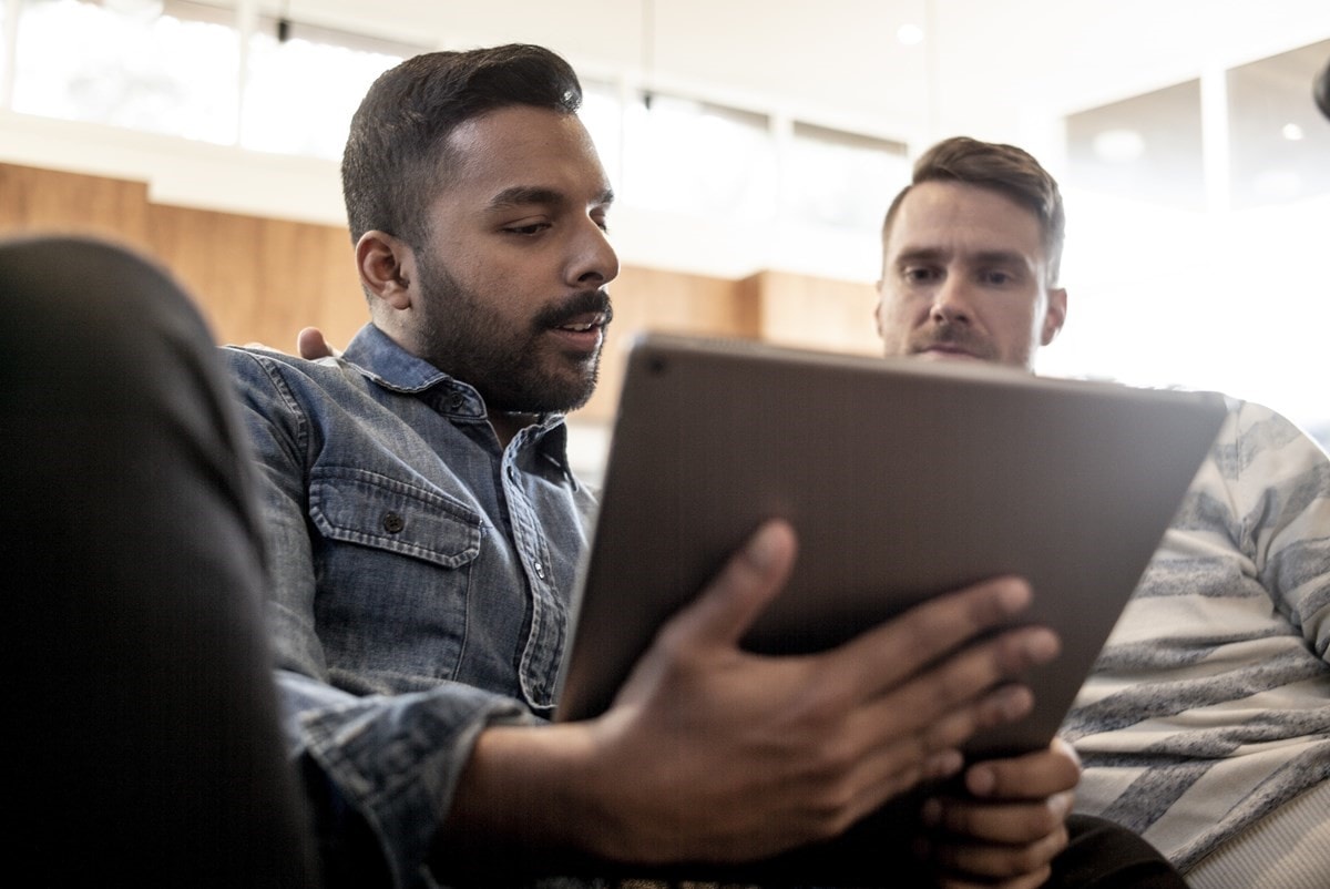 Couple on lounge with tablet