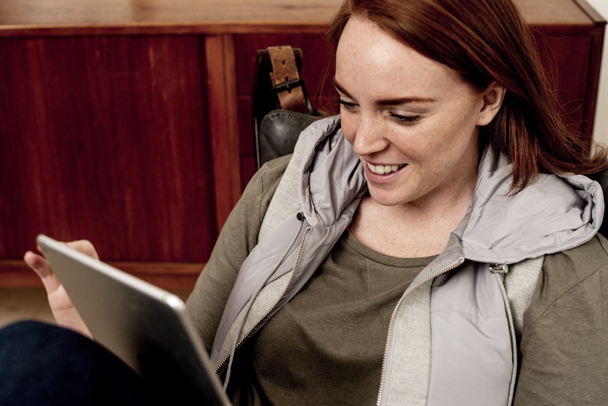 Young woman sitting with tablet