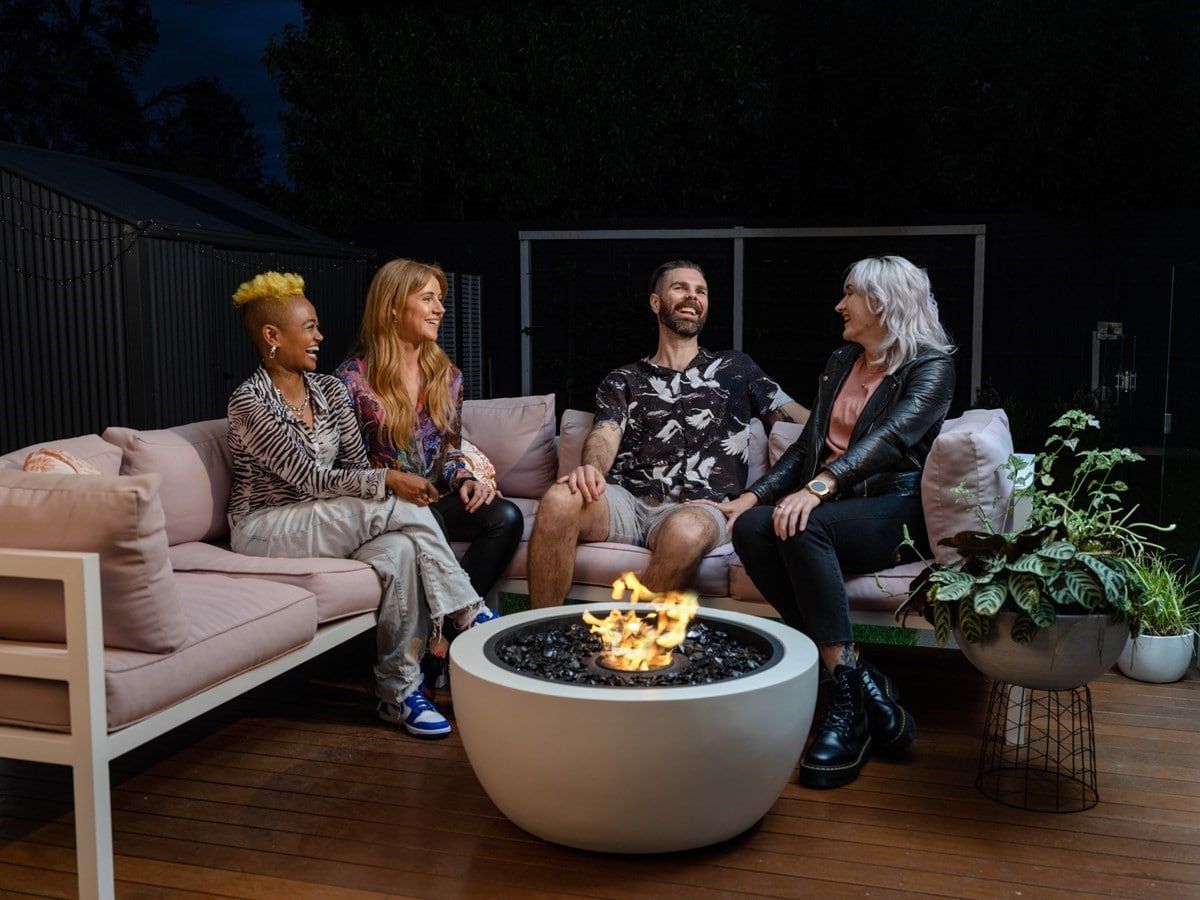 Young couples sitting around a stylish outdoor heater