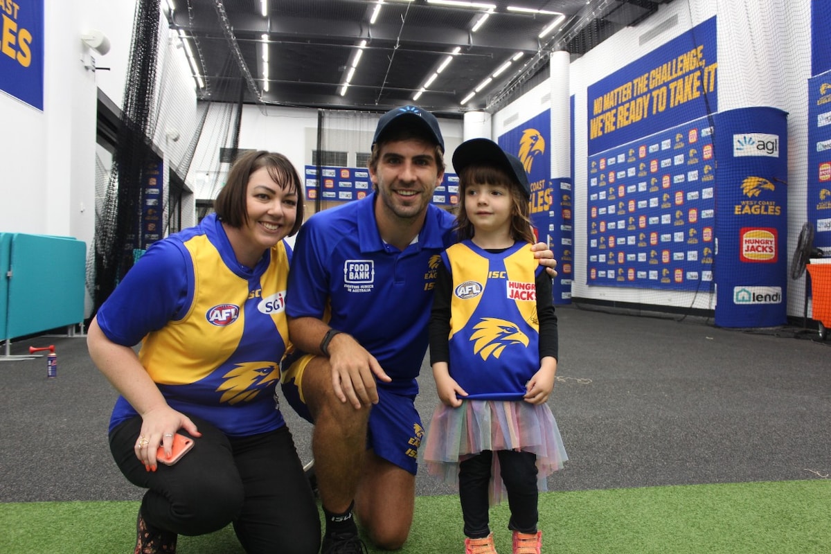 Andrew Gaff in the change rooms with two fans