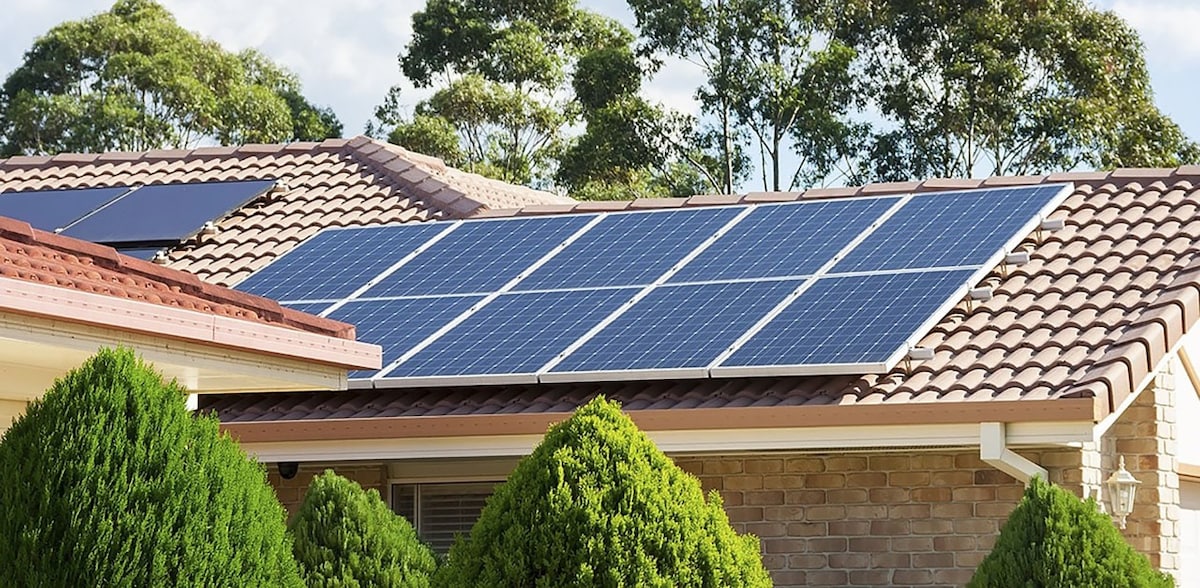 Suburban brick home with solar panels on roof