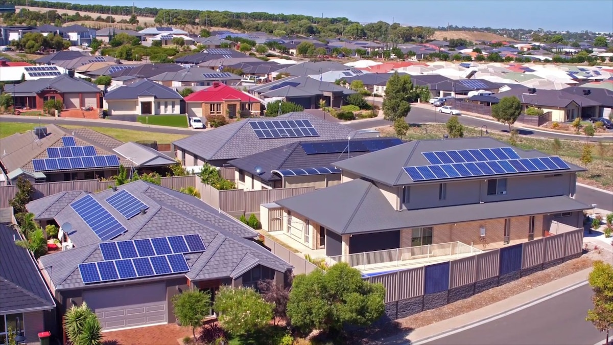 An aerial shot of residential houses with solar panels