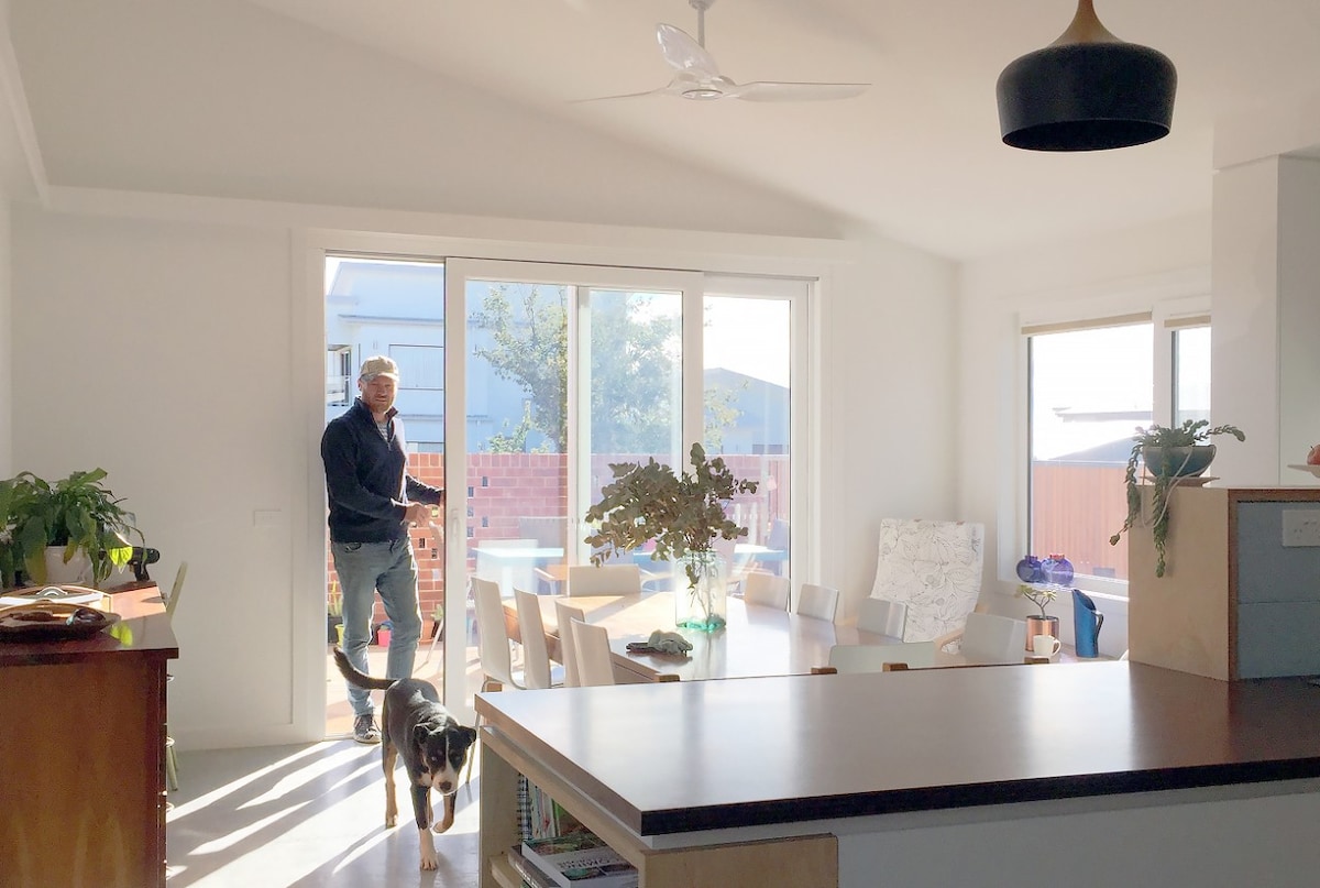Man and dog in dining room of 8.2 star home