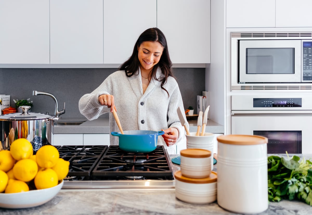 woman cooking on stove