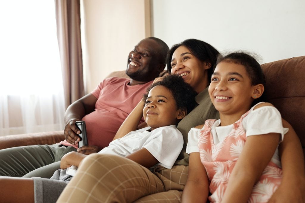 agl_ps_image_happy-family-sitting-on-a-couch-and-watching-tv-