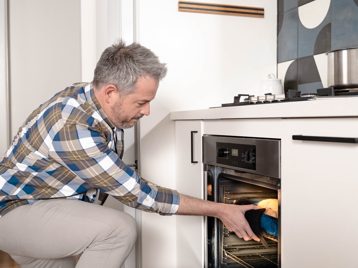 Man baking bread in his oven
