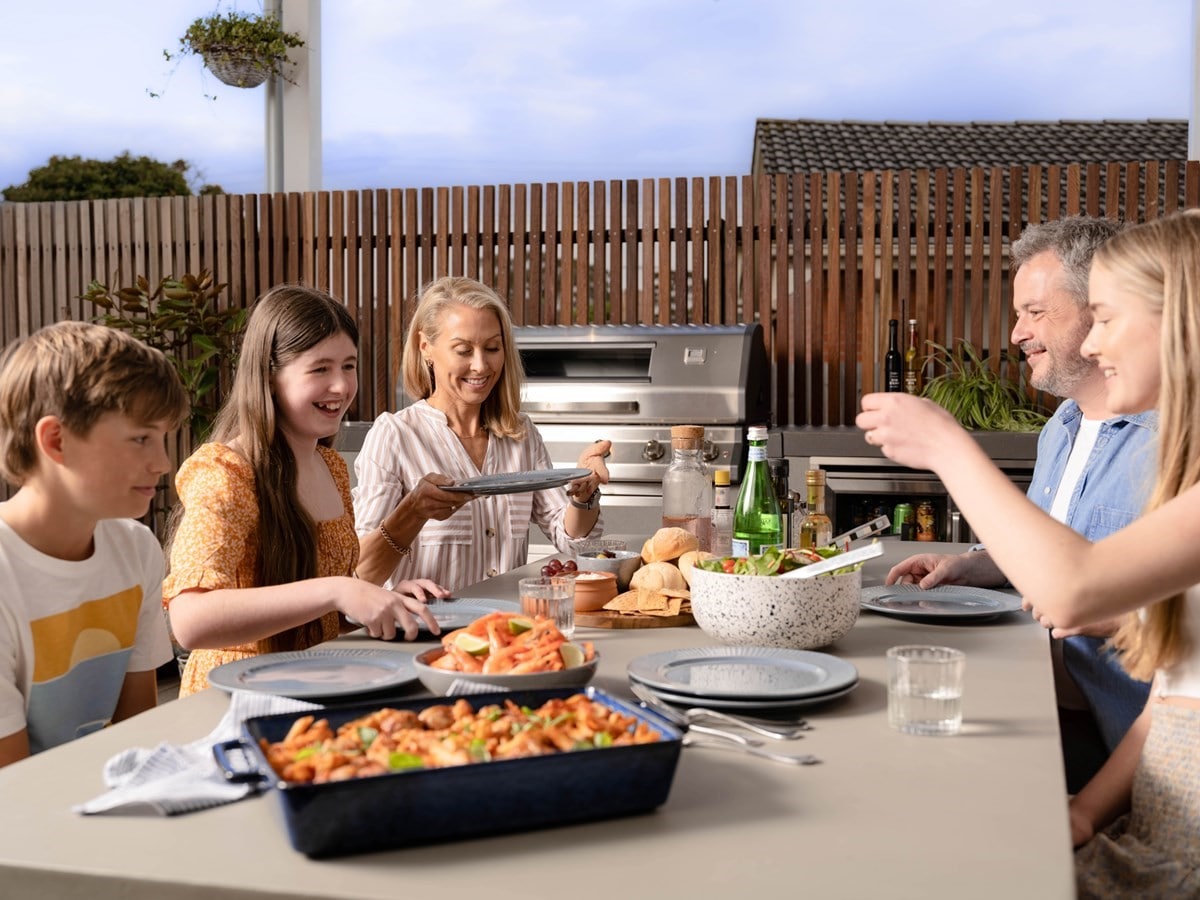 Family having dinner outside on deck
