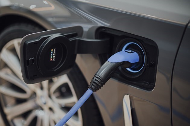 An EV charger plugged into an electric vehicle