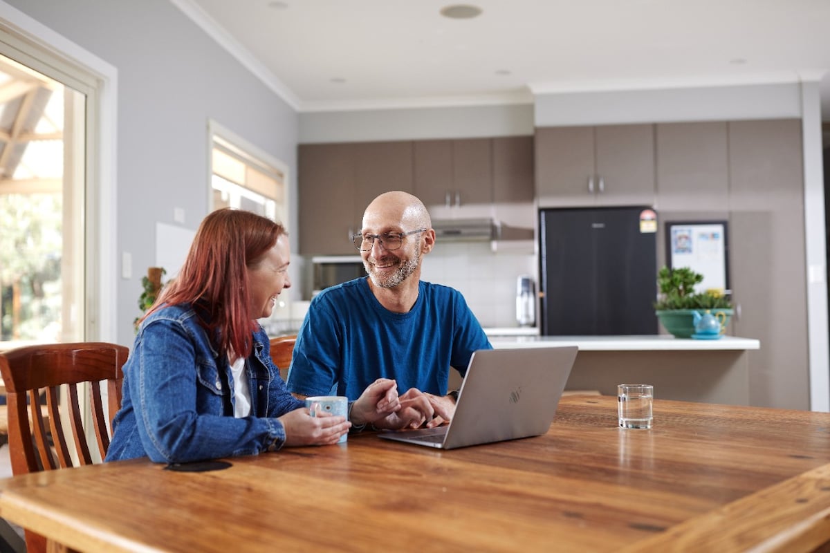 AGL customers John and Christina sitting at their kitchen table