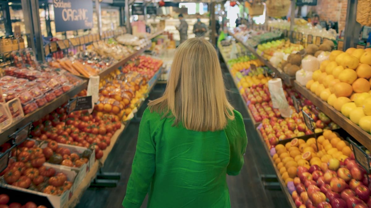 Yume founder walking through produce aisle in store 