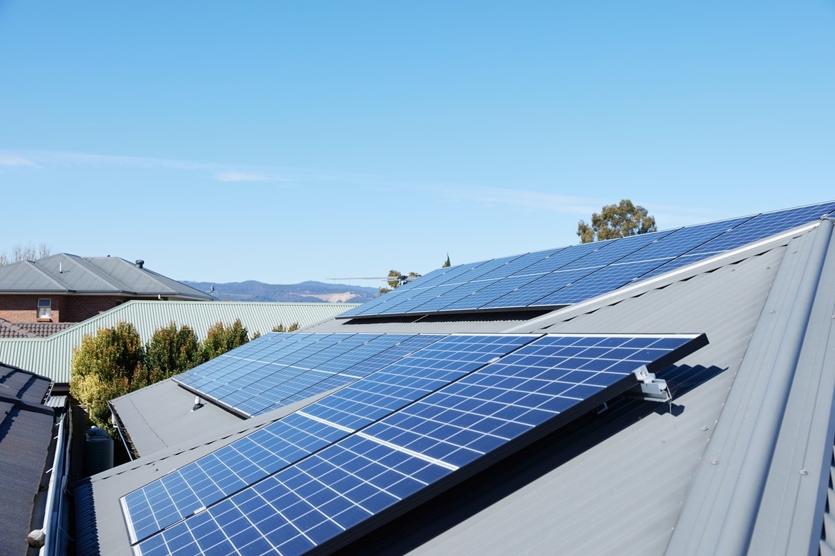 Rooftop solar panels and blue skies