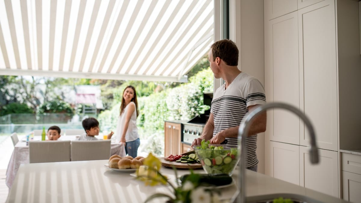 Family preparing lunch. Family preparing grill. Family have lunch on terrace.