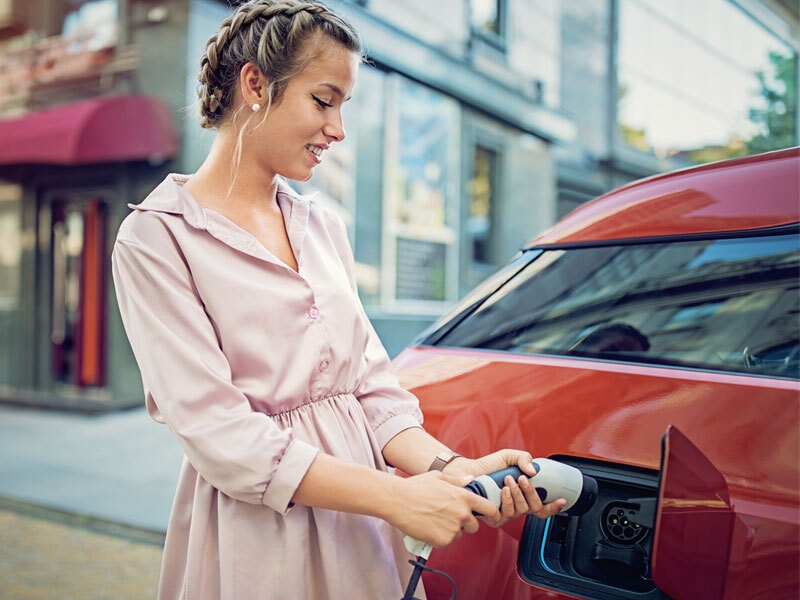 Closeup of grey EV with charger plugged in