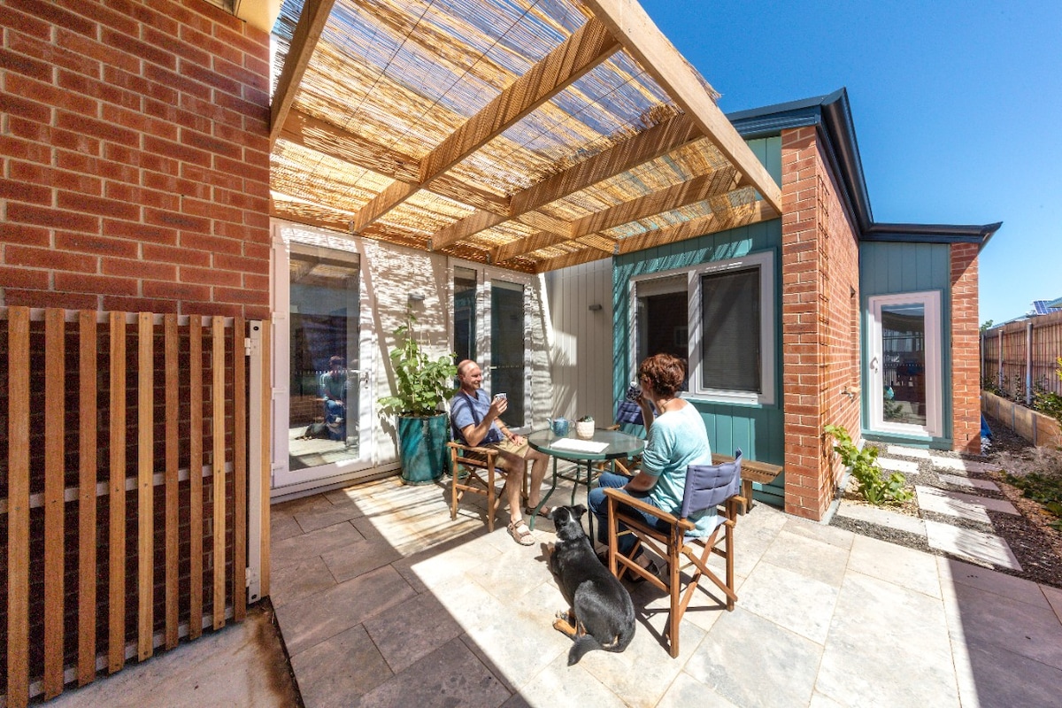 Older couple sitting on outdoor deck in summer