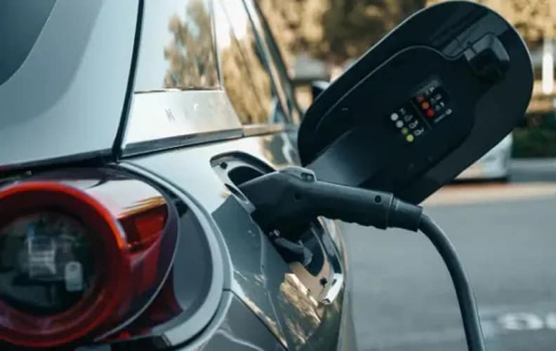 An EV plugged into an AGL branded public charger