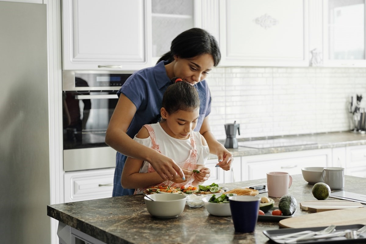 Mother and daughter cooking a meal