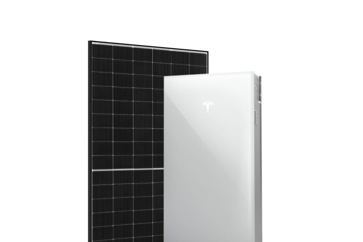 A solar panel behind a Tesla 3 Powerwall battery