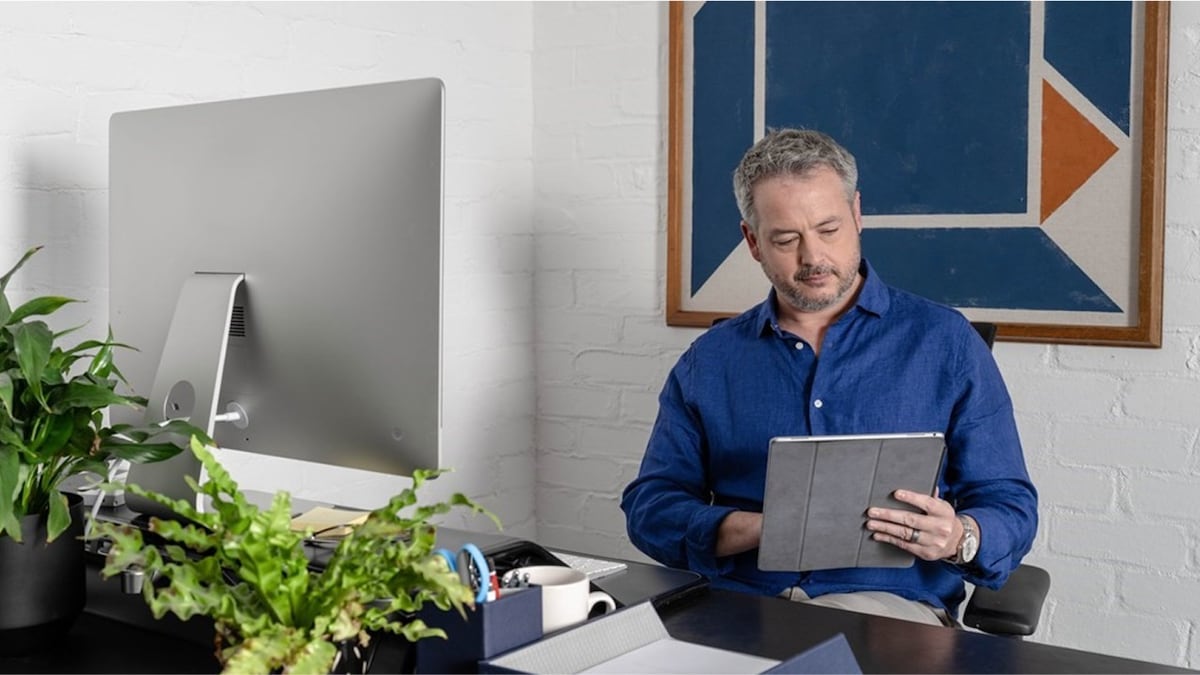 Man working in home office on tablet