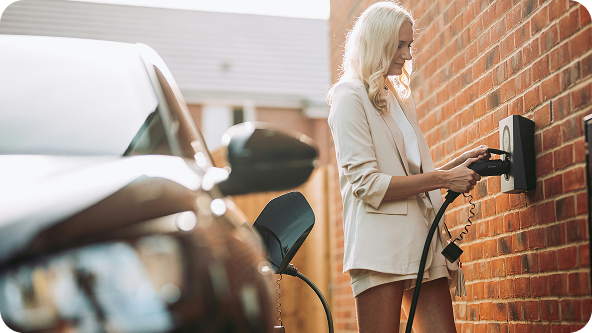 Woman plugging in an EV charger