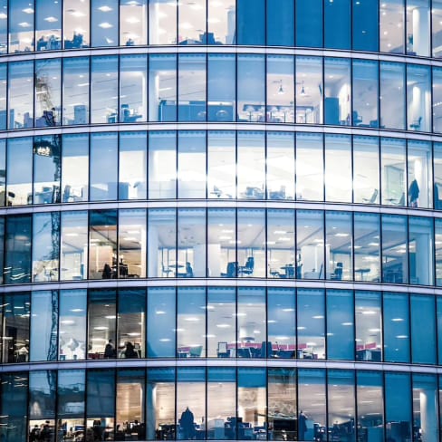 Shot of offices through a glass windows of a high-rise building 